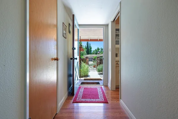 a view of hallway with wooden floor
