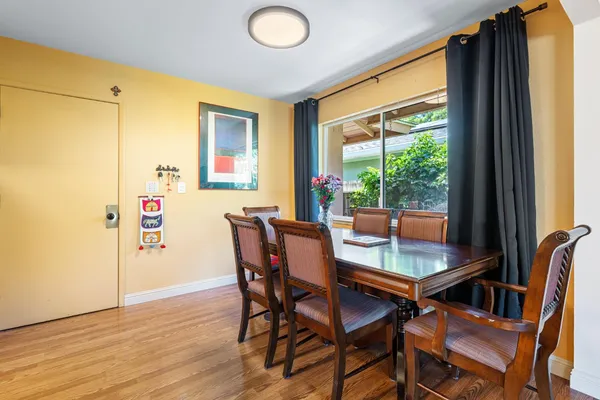 a dining room with furniture and a window