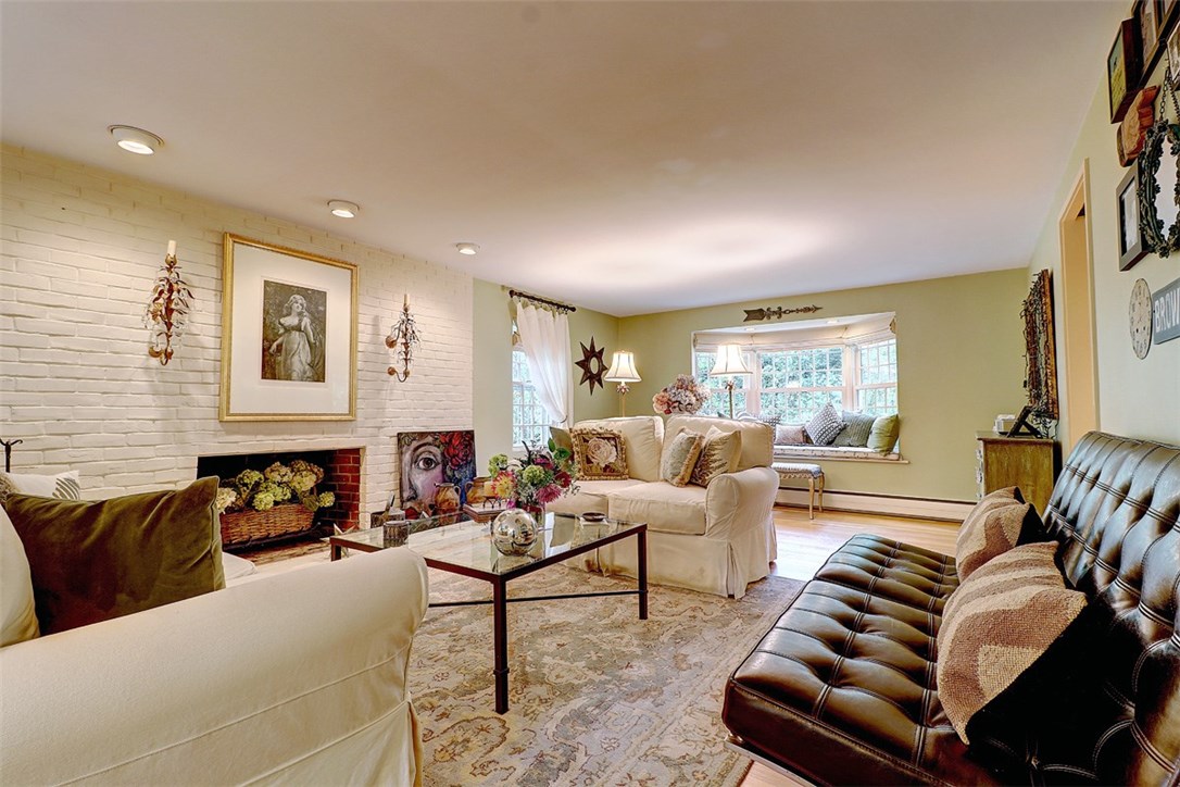 39 Major Potter Road Warwick, RI 02886 - Photo 15 of 32 living room with fireplace, hardwoods, window seat and a sense of elegance