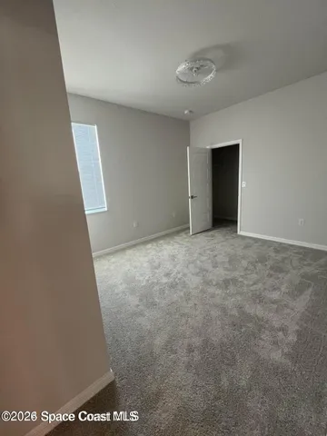 a view of an empty room with windows