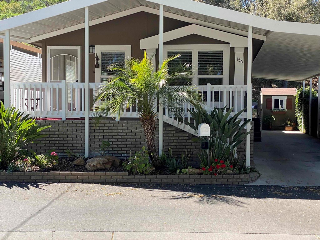 28890 Lilac Road, Unit 156 Valley Center, CA 92082 - Photo 1 of 1 a front view of a house with garden