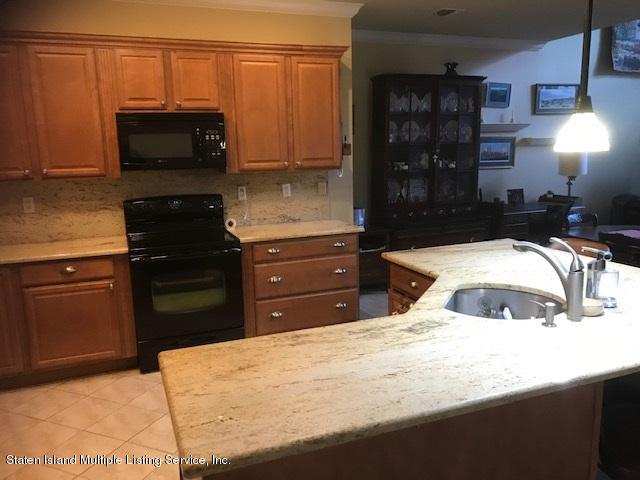 26 Tides Lane Staten Island, NY 10309 - Photo 11 of 41 a kitchen with a sink and a stove