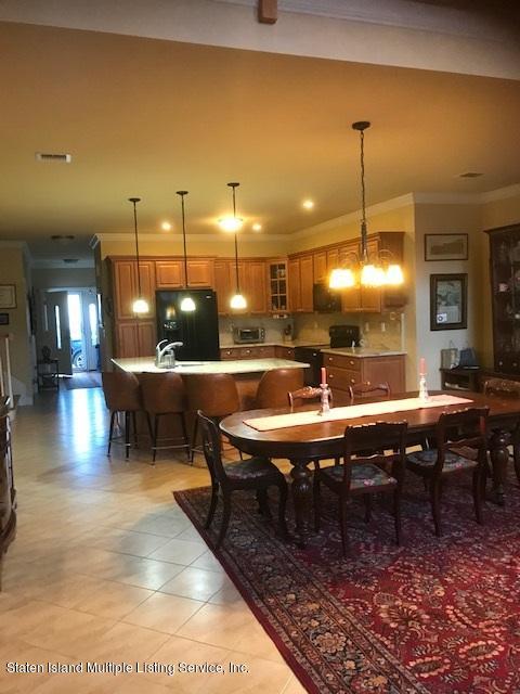 26 Tides Lane Staten Island, NY 10309 - Photo 16 of 41 a room with lots of wooden furniture and a chandelier