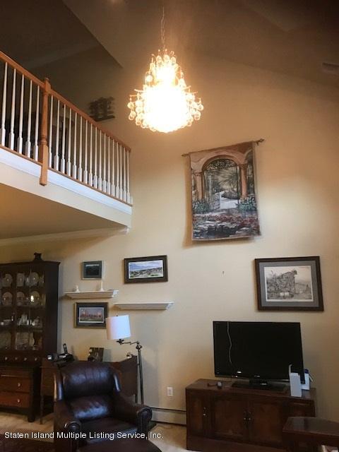 26 Tides Lane Staten Island, NY 10309 - Photo 17 of 41 a living room with furniture and a flat screen tv