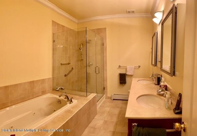 26 Tides Lane Staten Island, NY 10309 - Photo 21 of 41 a bathroom with a tub sink and mirror