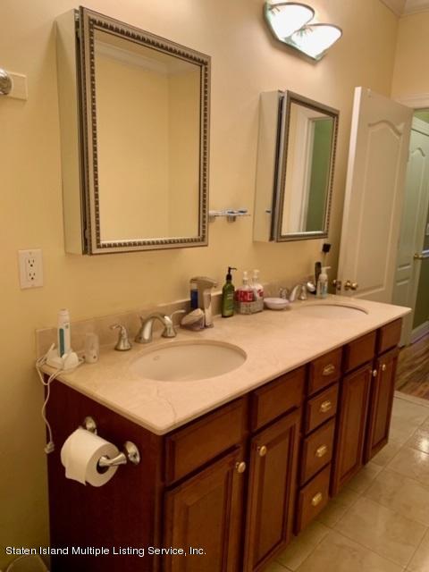 26 Tides Lane Staten Island, NY 10309 - Photo 22 of 41 a bathroom with a sink vanity and a mirror