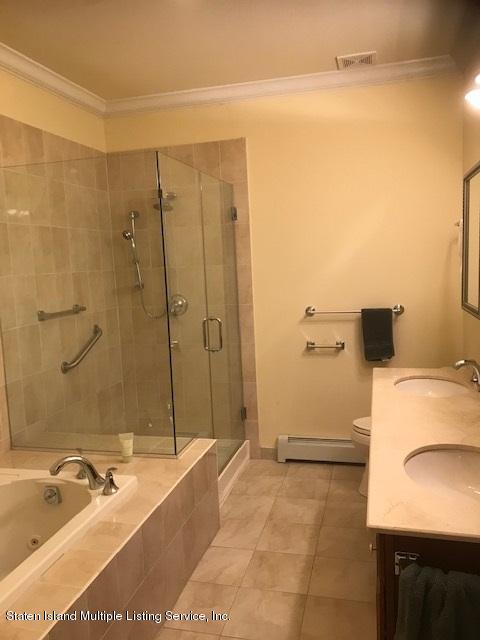 26 Tides Lane Staten Island, NY 10309 - Photo 23 of 41 a bathroom with a tub a sink and a shower