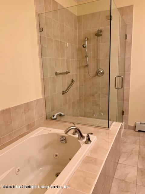 26 Tides Lane Staten Island, NY 10309 - Photo 24 of 41 a bathroom with a bathtub and shower