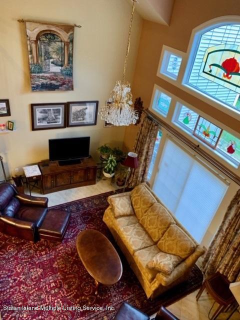 26 Tides Lane Staten Island, NY 10309 - Photo 27 of 41 a living room with furniture flowerpot and a chandelier