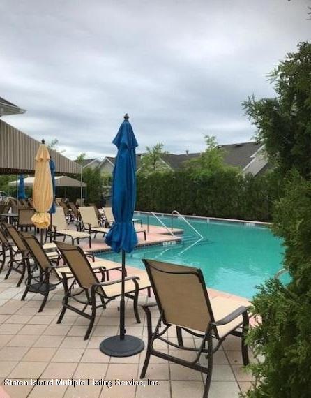 26 Tides Lane Staten Island, NY 10309 - Photo 30 of 41 a view of a chairs and table in patio with a yard