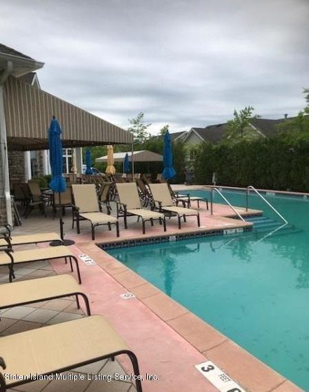 26 Tides Lane Staten Island, NY 10309 - Photo 31 of 41 a view of a swimming pool and lounge chairs in patio