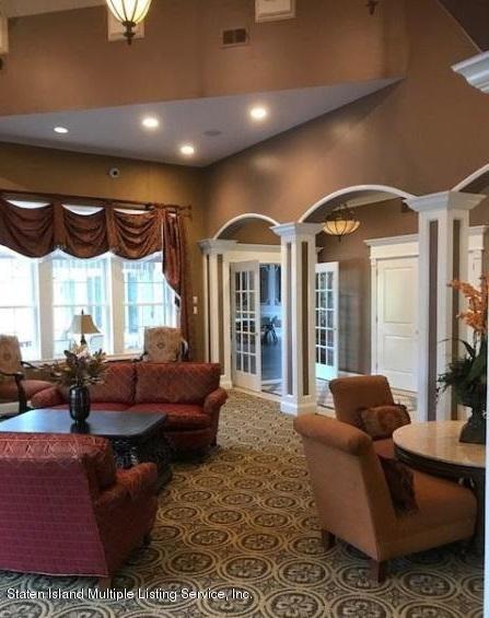 26 Tides Lane Staten Island, NY 10309 - Photo 37 of 41 a living room with furniture ceiling fan and a large window