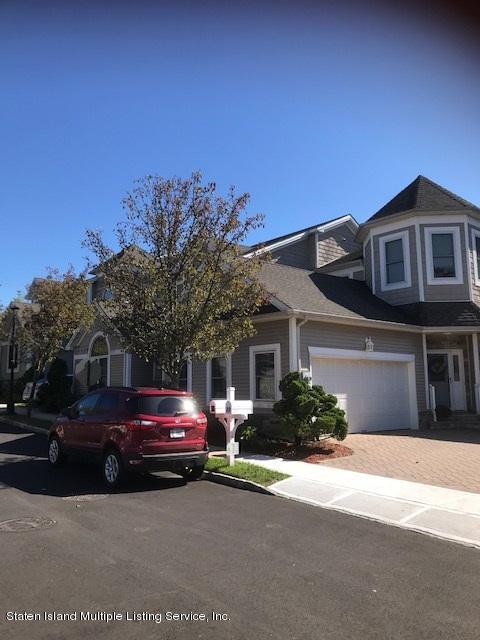 26 Tides Lane Staten Island, NY 10309 - Photo 4 of 41 a front view of a house with a yard and garage