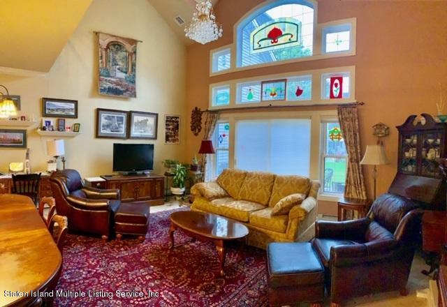 26 Tides Lane Staten Island, NY 10309 - Photo 6 of 41 a living room with furniture workspace and a flat screen tv