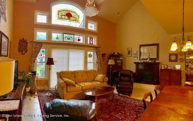 26 Tides Lane Staten Island, NY 10309 - Photo 7 of 41 a living room with furniture and a flat screen tv