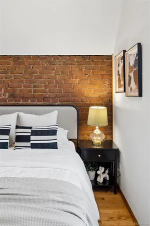 a bedroom with a bed and wall painting