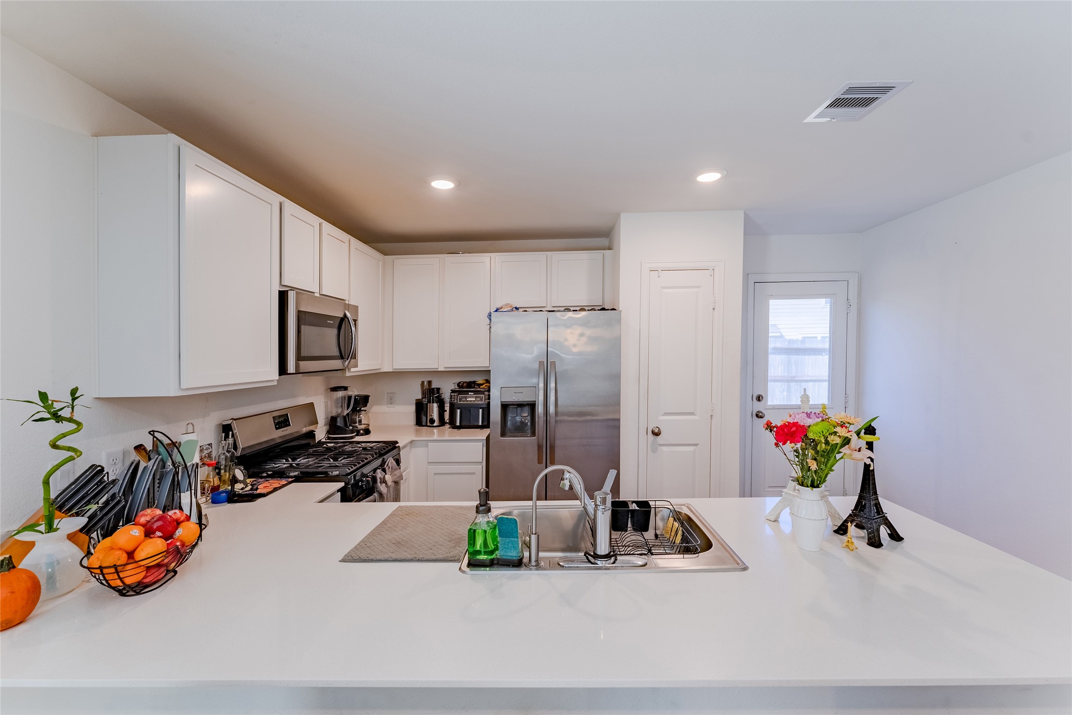 4143 Saltillo Lakes Drive Baytown, TX 77521 - Photo 13 of 29 a kitchen with a refrigerator and a sink
