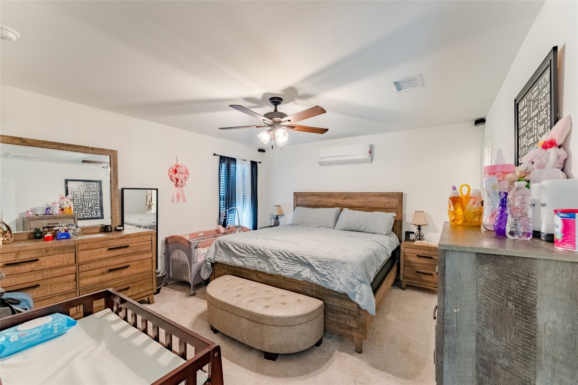 4143 Saltillo Lakes Drive Baytown, TX 77521 - Photo 14 of 29 a bedroom with a bed and a chandelier