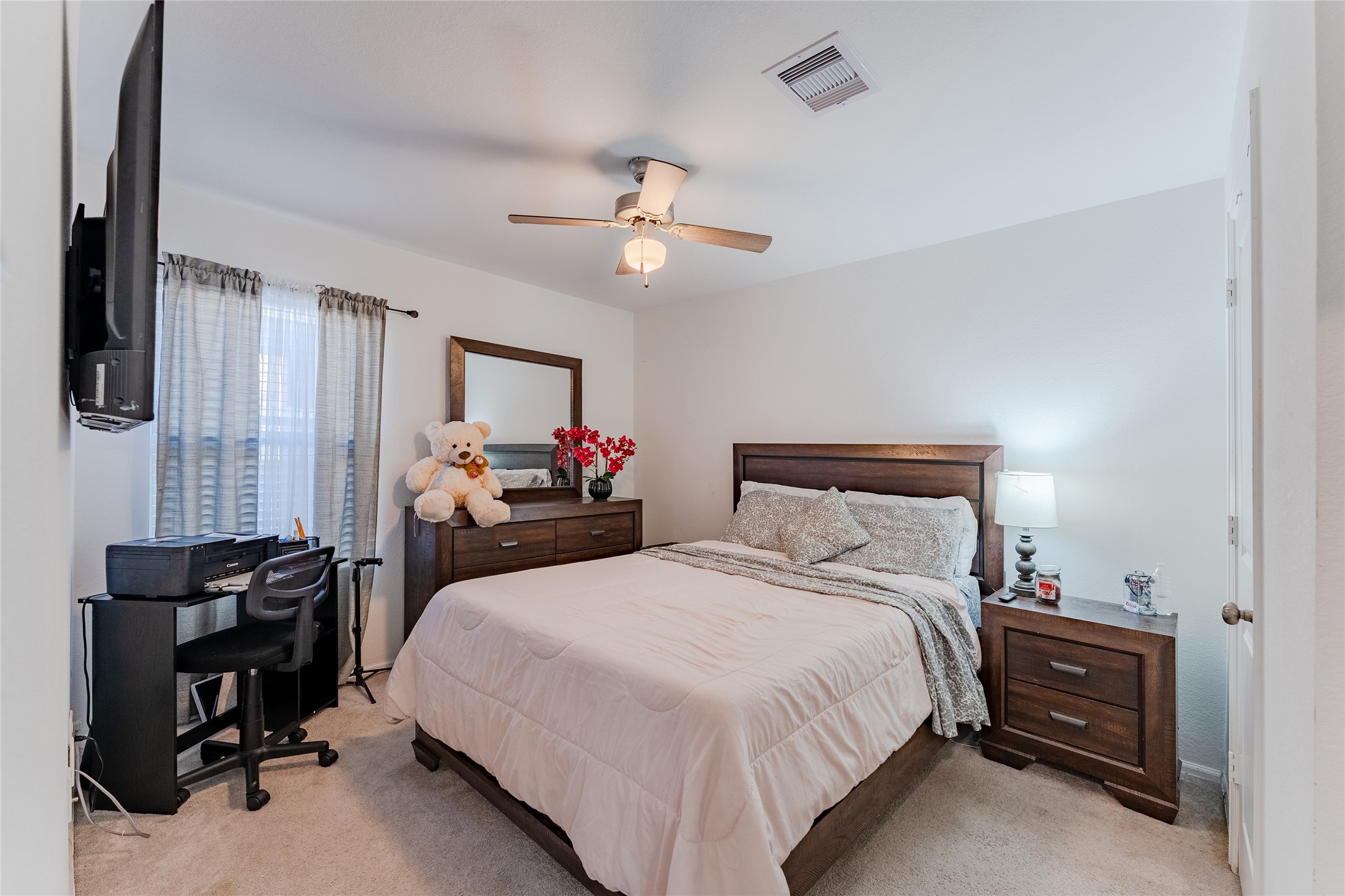 4143 Saltillo Lakes Drive Baytown, TX 77521 - Photo 17 of 29 a bedroom with a bed and a chandelier