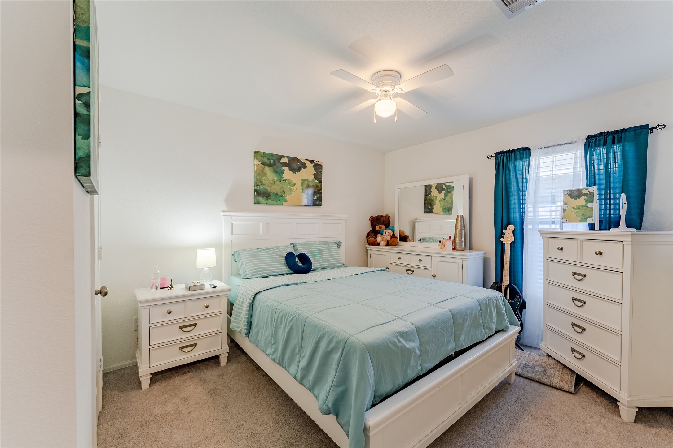 4143 Saltillo Lakes Drive Baytown, TX 77521 - Photo 19 of 29 a bedroom with a bed and a chandelier