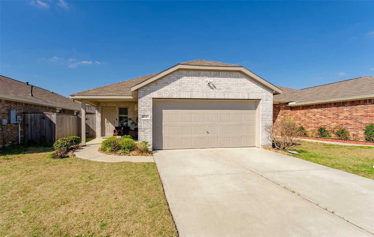 4143 Saltillo Lakes Drive Baytown, TX 77521 - Photo 4 of 29 a front view of a house with a yard and garage