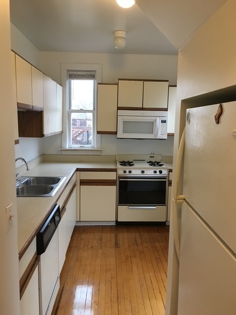 3018 North Racine Avenue, Unit 2R Chicago, IL 60657 - Photo 2 of 6 a kitchen with a refrigerator and a sink