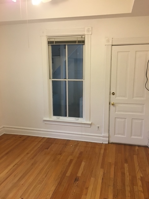 3018 North Racine Avenue, Unit 2R Chicago, IL 60657 - Photo 3 of 6 a view of an empty room with wooden floor and a window