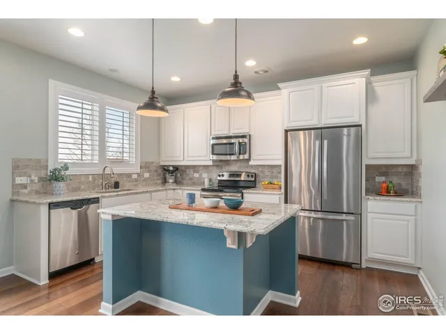 a kitchen with refrigerator cabinets and a sink