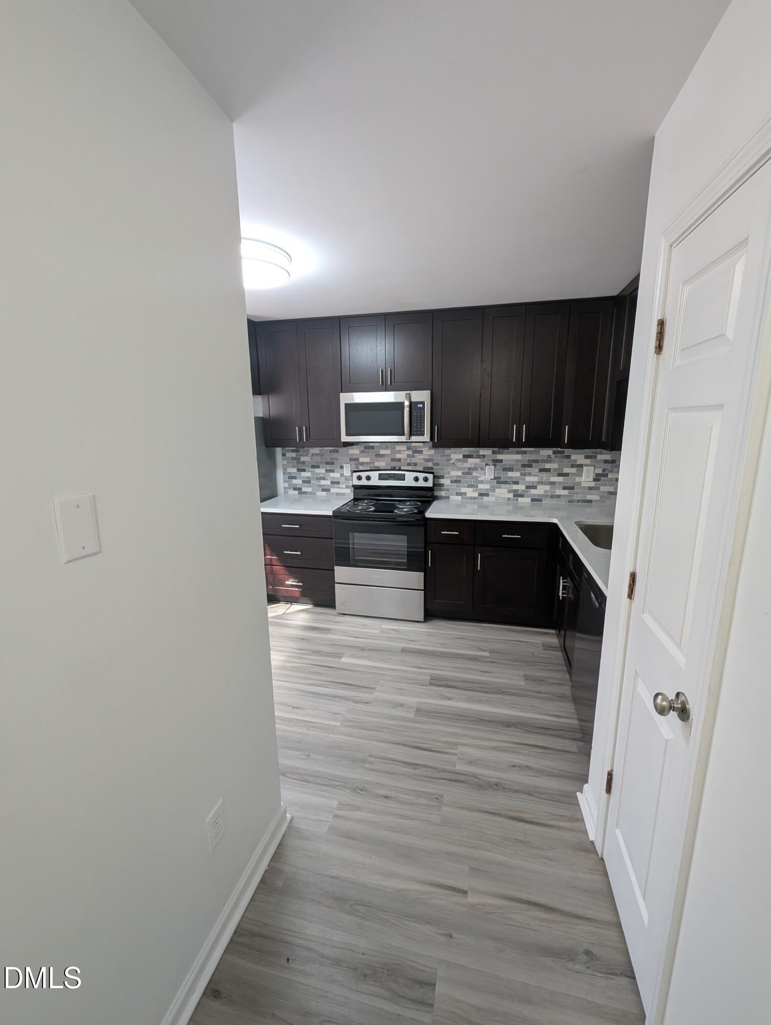 1005 Shades Place Raleigh, NC 27601 - Photo 4 of 18 a view of kitchen with wooden floor and electronic appliances