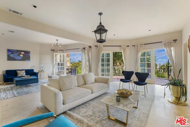 a living room with furniture and floor to ceiling window