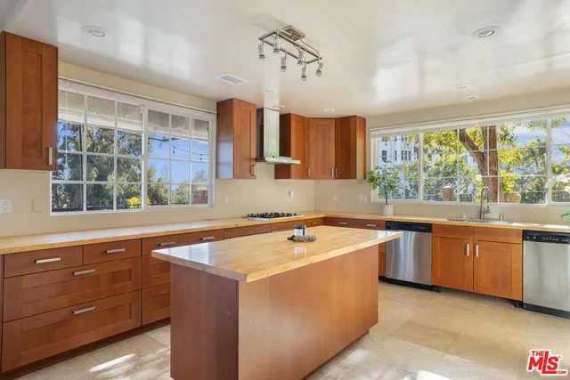 a kitchen with stainless steel appliances granite countertop a sink and dishwasher a stove with wooden floor