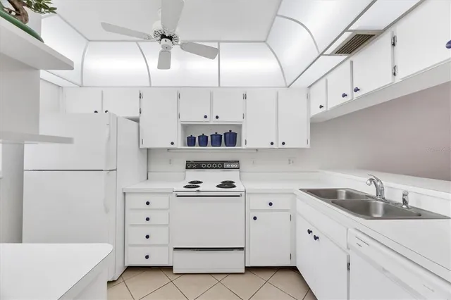 a kitchen with cabinets appliances and a sink