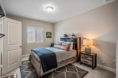 a bedroom with a bed and a window