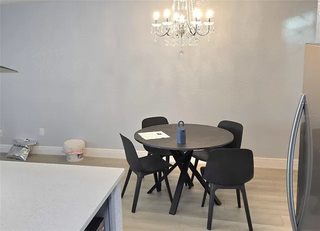 a view of a dining room with furniture and chandelier