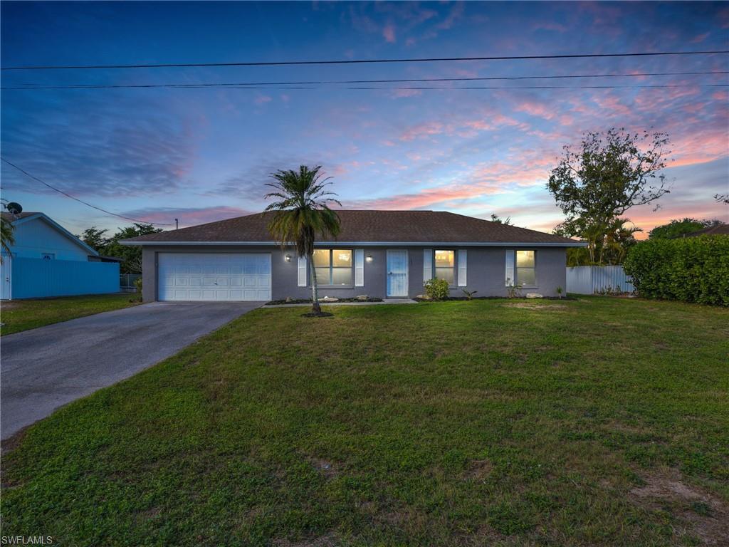 4991 18th Court Southwest Naples, FL 34116 - Photo 1 of 36 a front view of a house with a garden