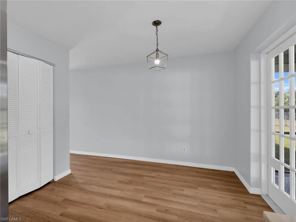 4991 18th Court Southwest Naples, FL 34116 - Photo 13 of 36 a view of empty room with wooden floor and fan