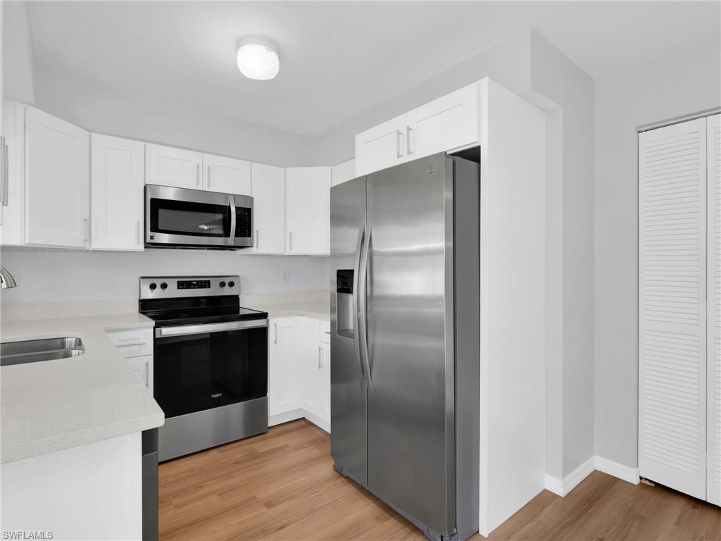 4991 18th Court Southwest Naples, FL 34116 - Photo 15 of 36 a metallic refrigerator freezer sitting in a kitchen