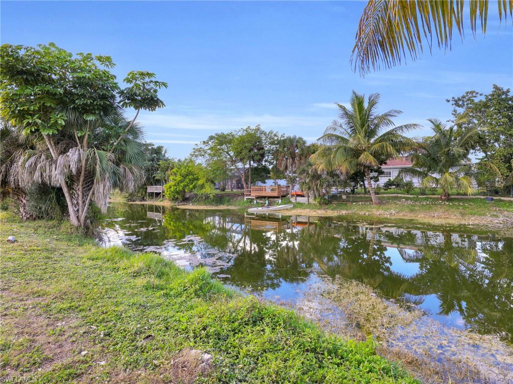 4991 18th Court Southwest Naples, FL 34116 - Photo 28 of 36 a view of a lake with a big yard