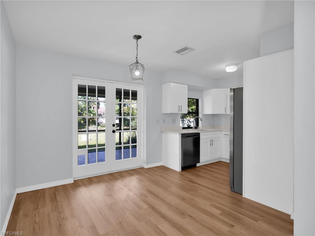 4991 18th Court Southwest Naples, FL 34116 - Photo 3 of 36 a view of a kitchen with refrigerator and wooden floor