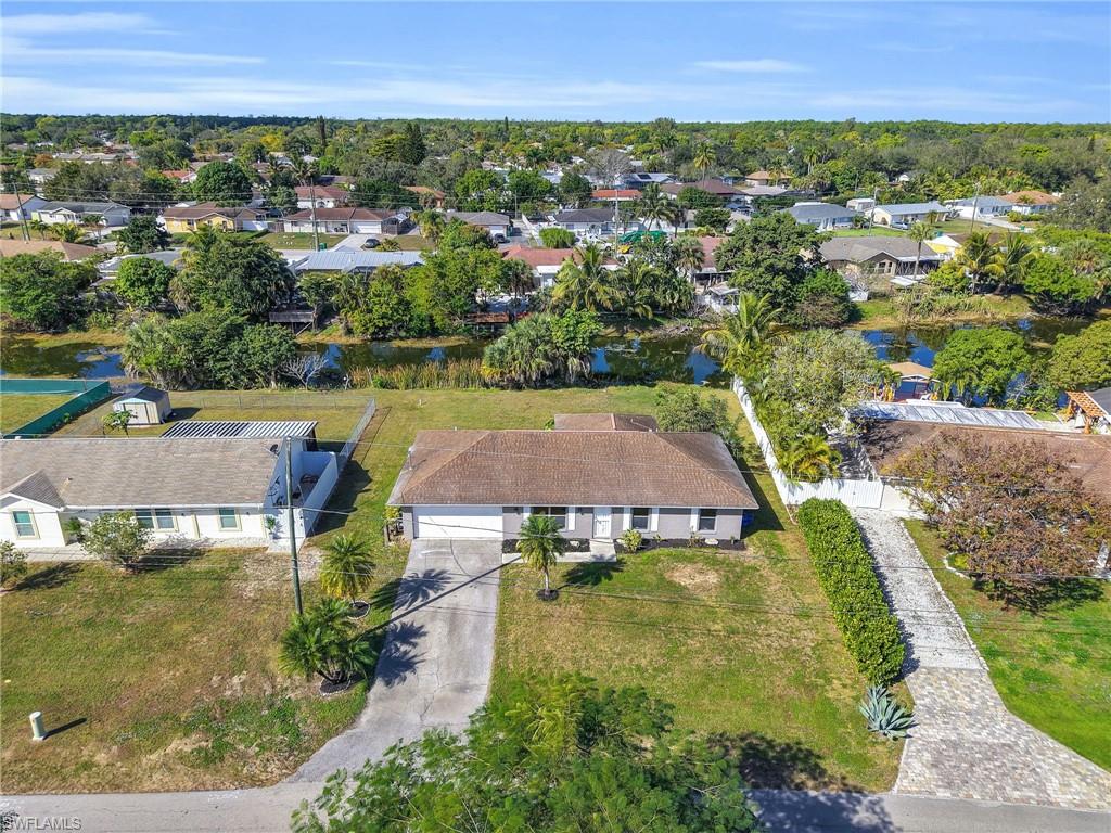 4991 18th Court Southwest Naples, FL 34116 - Photo 32 of 36 an aerial view of residential houses with outdoor space and trees