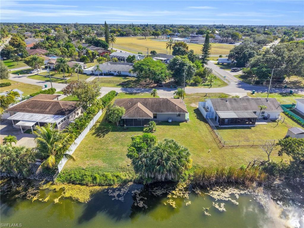4991 18th Court Southwest Naples, FL 34116 - Photo 34 of 36 an aerial view of residential houses with outdoor space and lake view