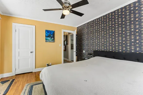 a bedroom with a bed and wooden floor