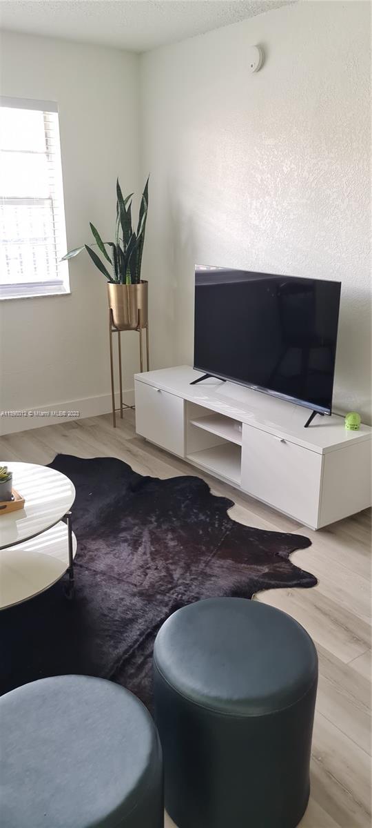 444 Southwest 4th Street, Unit 102 Miami, FL 33130 - Photo 2 of 11 a living room with furniture and a potted plant