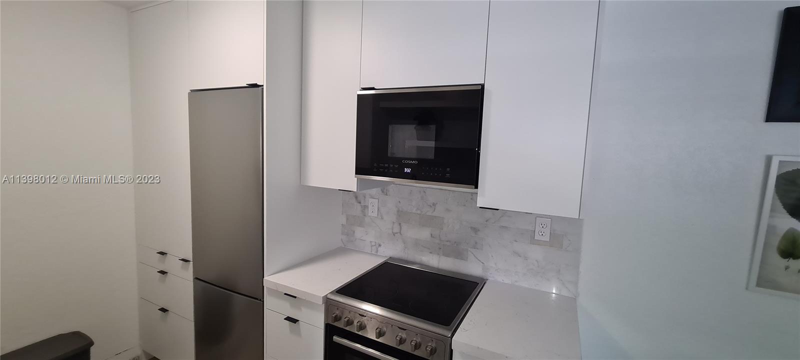 444 Southwest 4th Street, Unit 102 Miami, FL 33130 - Photo 7 of 11 a bathroom with a sink and washing machine