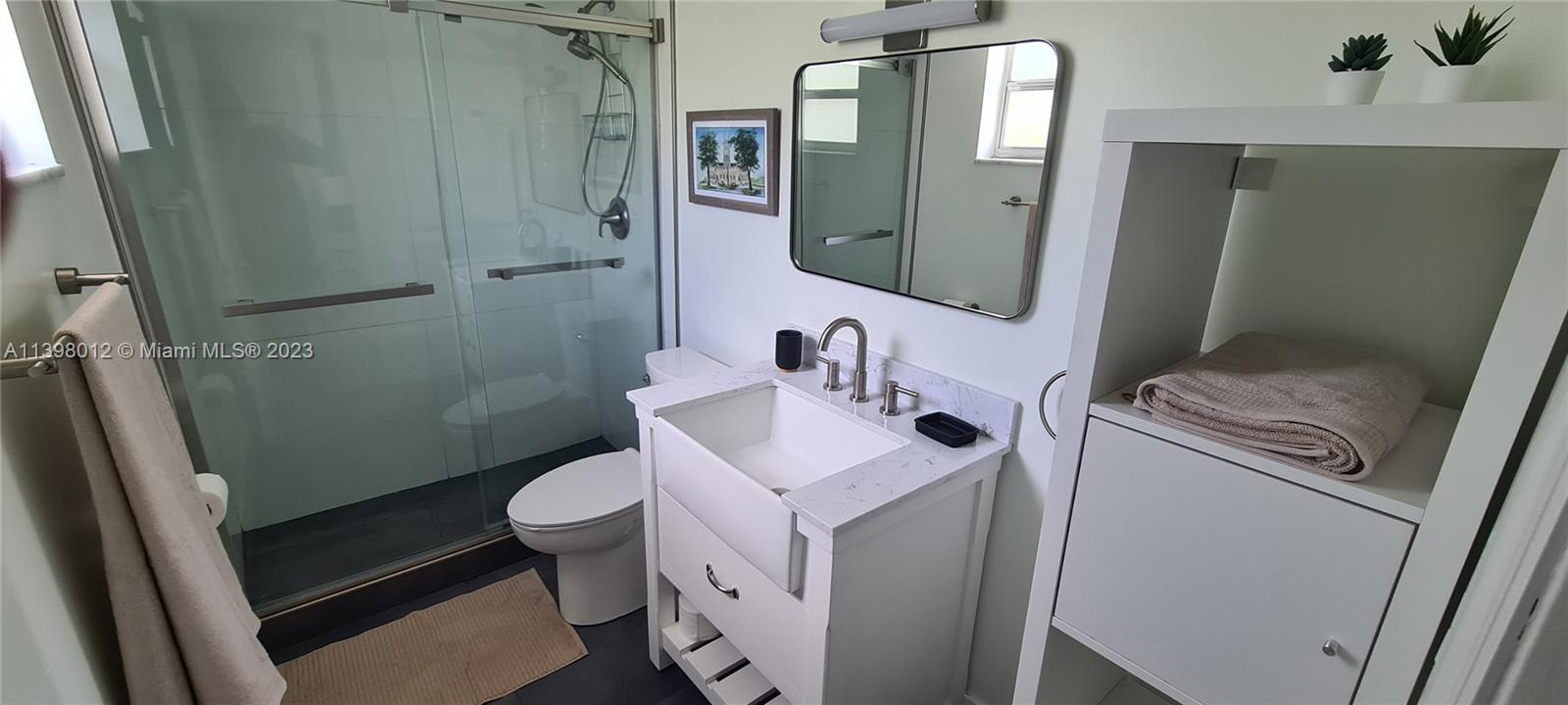 444 Southwest 4th Street, Unit 102 Miami, FL 33130 - Photo 9 of 11 a bathroom with a sink toilet and shower