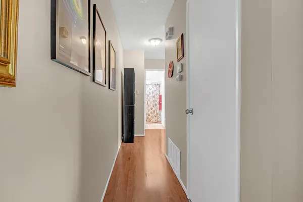a view of a hallway with wooden floor