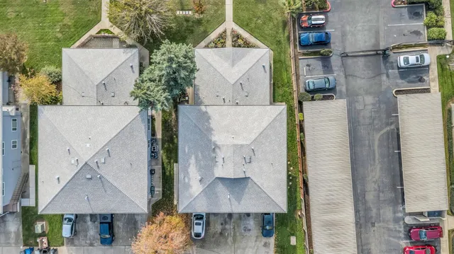 an aerial view of a house with a yard and a fountain