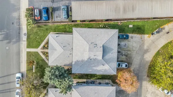 an aerial view of a residential houses with outdoor space