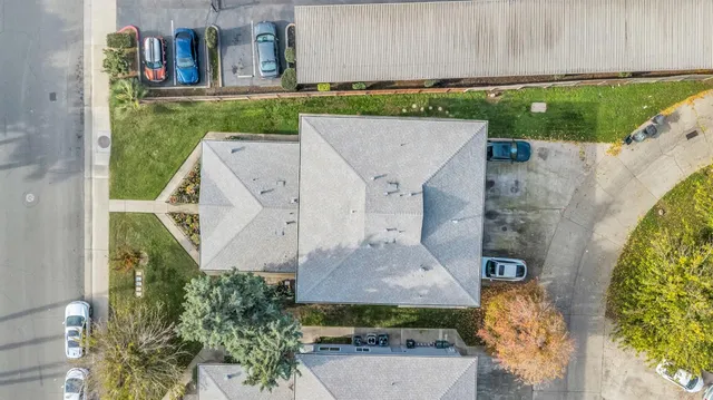 an aerial view of a residential houses with outdoor space