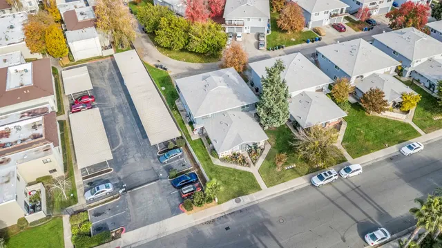 an aerial view of residential houses with outdoor space